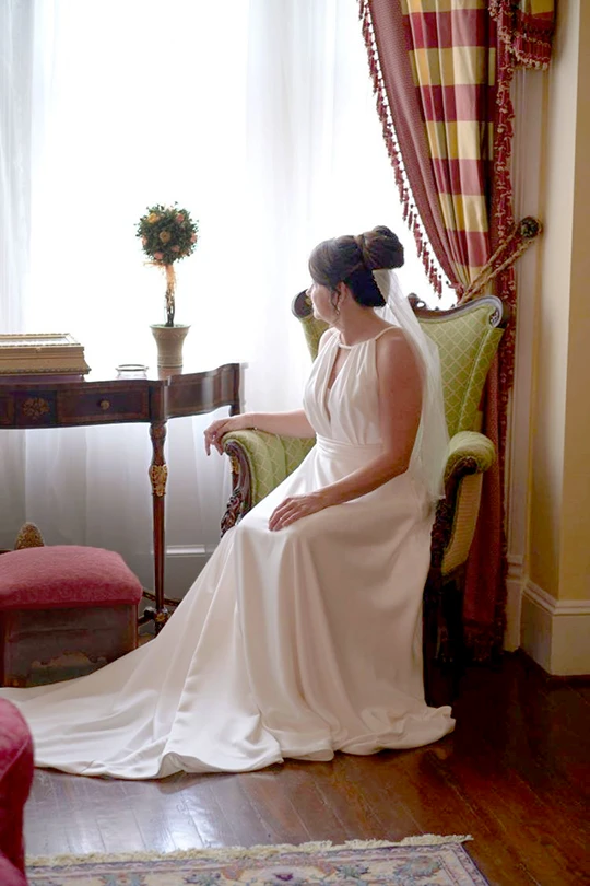 Bride looking out window - wedding venues event space in Fredericksburg VA