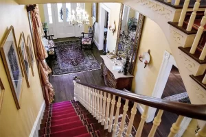 View of foyer from stairway landing at 1890 Caroline House