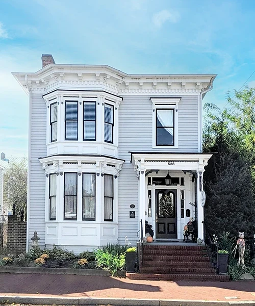 1890 Caroline House Front decorated with pumpkins and other fall decor