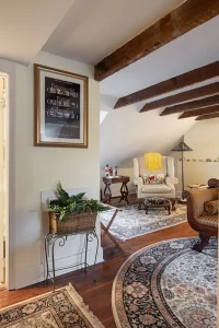 The Frejus bedroom with seating area, box window, and en suite bathroom