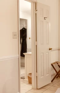 Isabella's Suite view to bathroom with plush robe hanging