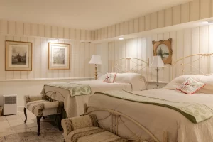 Isabella's Suite warm, off-white bedroom with two queen beds