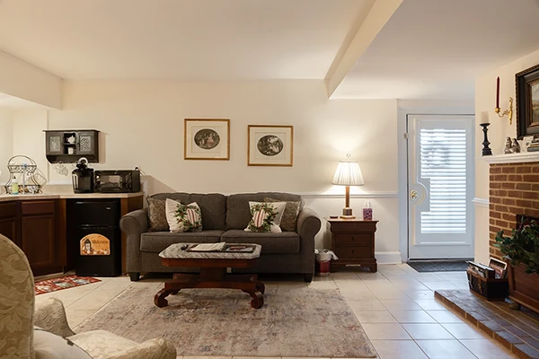 Isabella's Suite living room area with comfortable seating and decorative fireplace