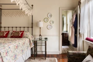 Olivia's Room bed and porcelain wall art with view to bathroom