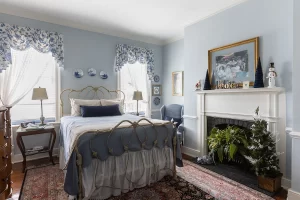 Peyton Mae soft blue bedroom with decorative fireplace