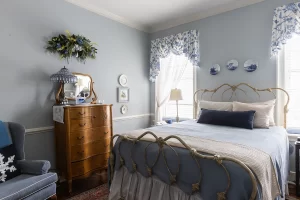 Peyton Mae bedroom with antique dresser, sitting area, and windows