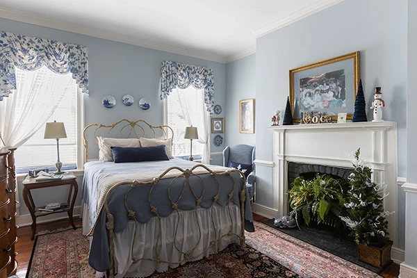 Peyton Mae soft blue bedroom with decorative fireplace