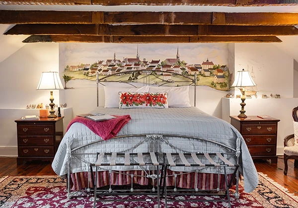 The Old Town bedroom with large mural of Fredericksburg and exposed beam ceiling