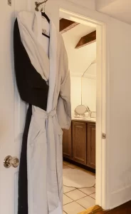 The Old Town view into bathroom with plush robe hanging on the door.