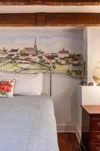The Old Town bedroom closeup of part of the mural of Fredericksburg and unique inset-outset wall design